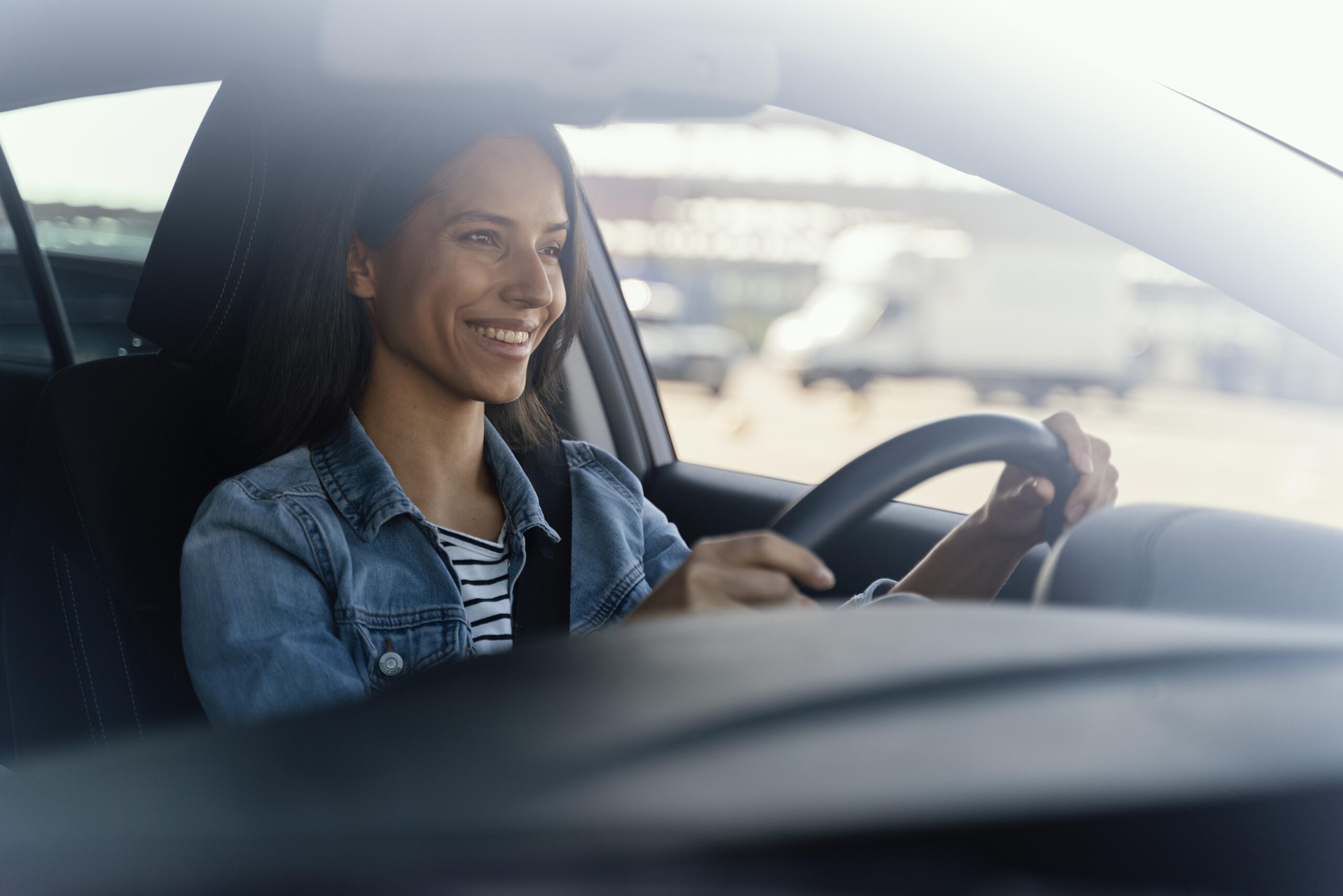 Mulher dirigindo seu carro feliz